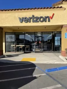 Hesperia, California Verizon store in beige shopping plaza with large sign above door.