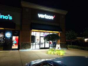 Antelope, California Verizon store at night with signage above door illuminated.