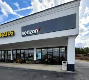 Centre, Alabama Verizon store exterior of the building showing storefront windows and door from outside of plaza.