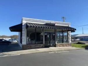 Crescent City, California VerizonÂ Store stand alone building with awnings and storefront windows wrapped around