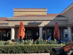 Irvine, California Verizon Store with tables and large umbrellas on front patio.