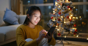 Asian-looking Female with phone and Christmas Tree Victra Verizon Store Near ME