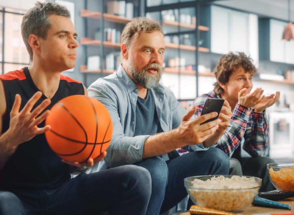 March Madness guys watching basketball game