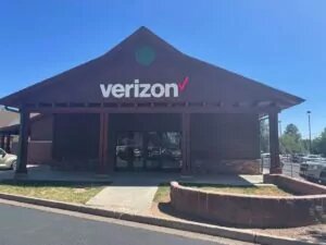Stand alone building Verizon store with wood columns and pointy top.