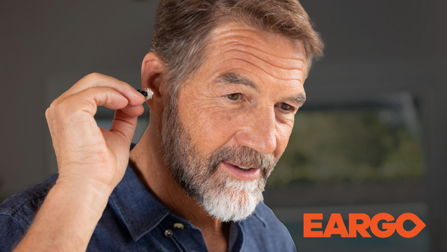 Eargo - man putting hearing aid in ear
