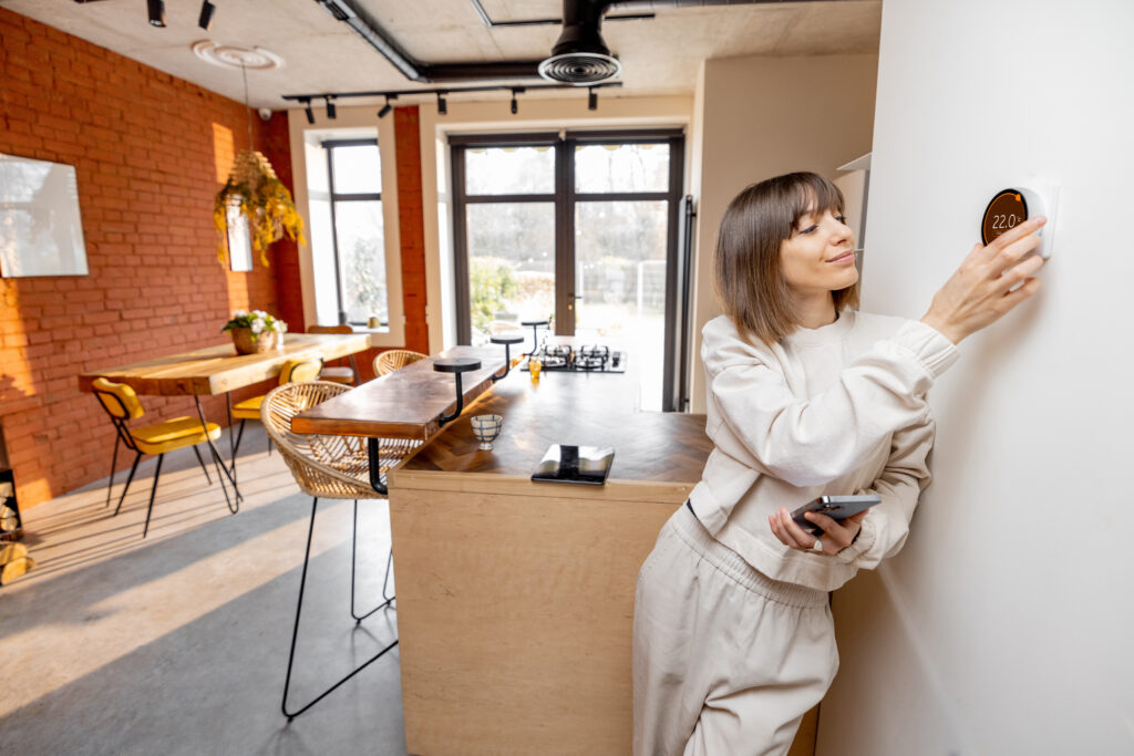 Woman-Adjusting-Modern-Termostat