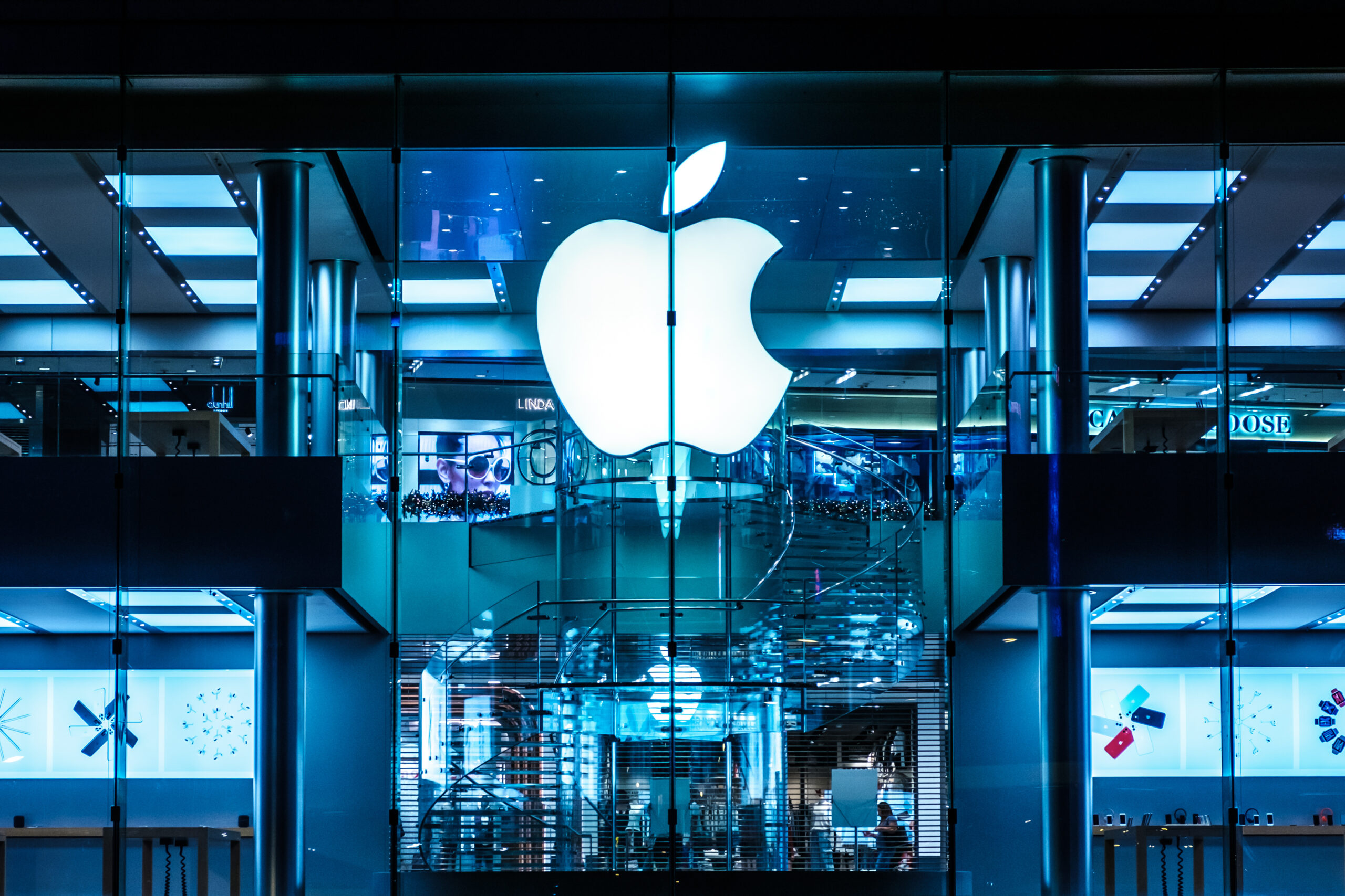 Apple Inc large storefront window showing Apple Inc logo.