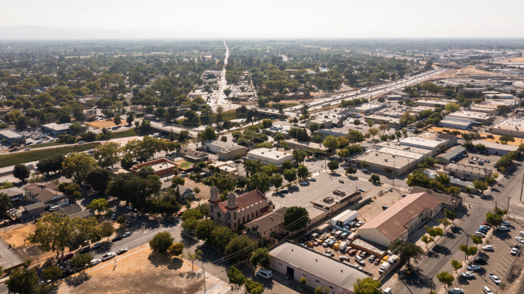 Afternoon aerial view of the 99 Freeway and urban downtown core of Modesto, California, USA.