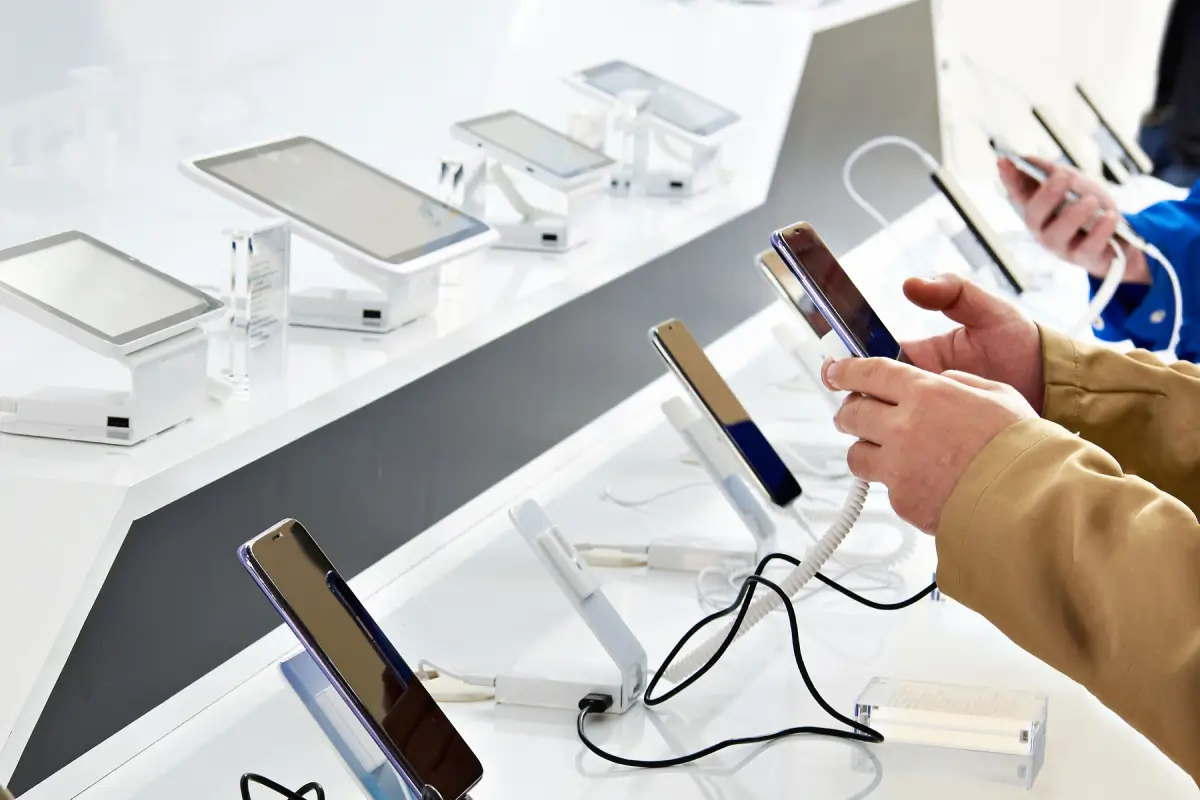 Customers demo new smartphones inside a store.