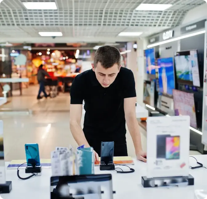A man looks over the smartphone selection at the Verizon Wireless Store.
