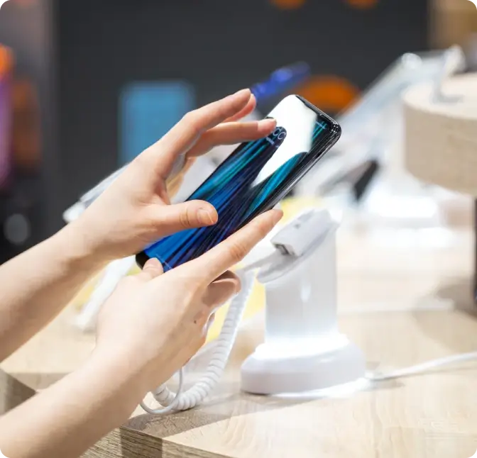 A person explores the new features of a smartphone at the Verizon Wireless store.