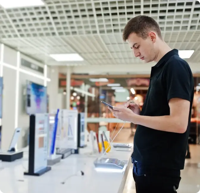 A man tries out a new smartphone at the Verizon Wireless store.