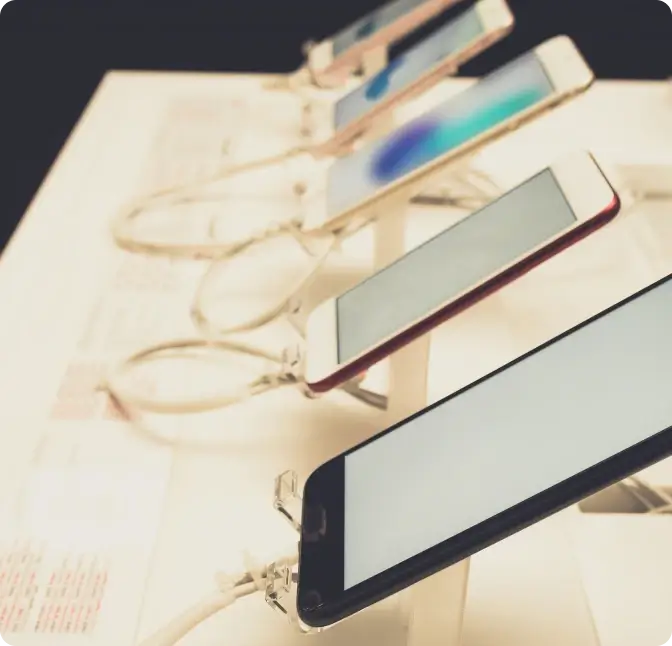 Five smartphones displayed in a row at Verizon Wireless in Plymouth.