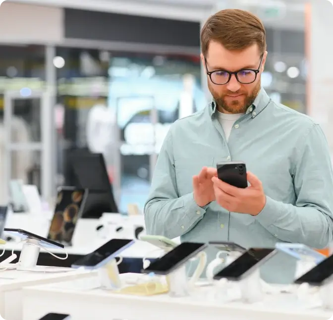 A man shopping for smartphones at the Verizon store.