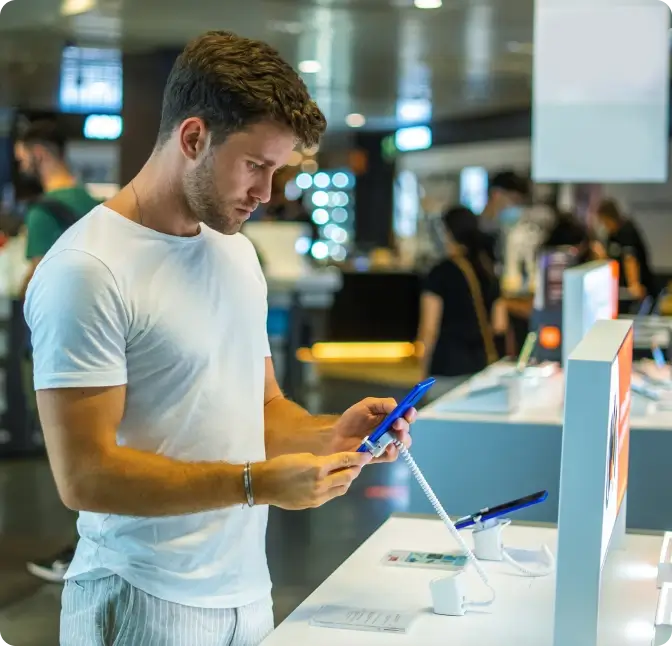 A man tries out the features of a new smartphone from Verizon Wireless.