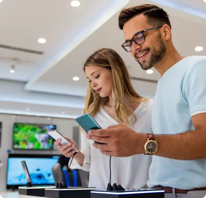 A couple explores the latest feature of the newest smartphones at Verizon Wireless.